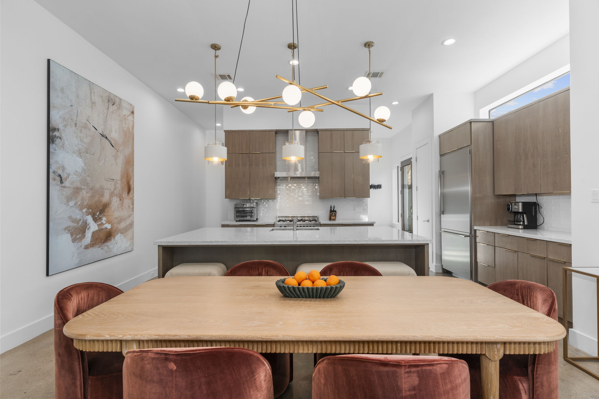 Dining area with velvet chairs and modern light fixture
