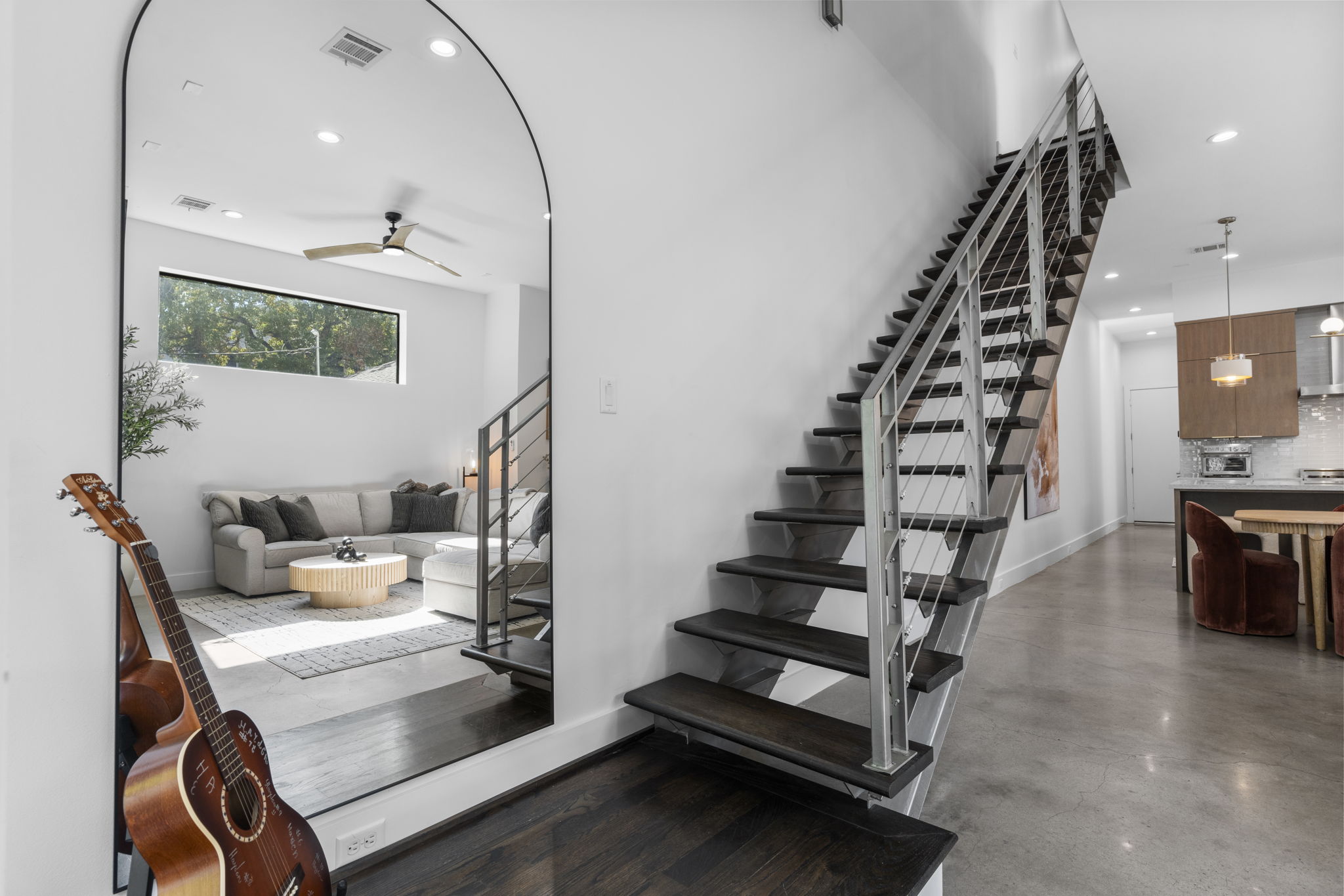 Staircase and arched mirror in living area