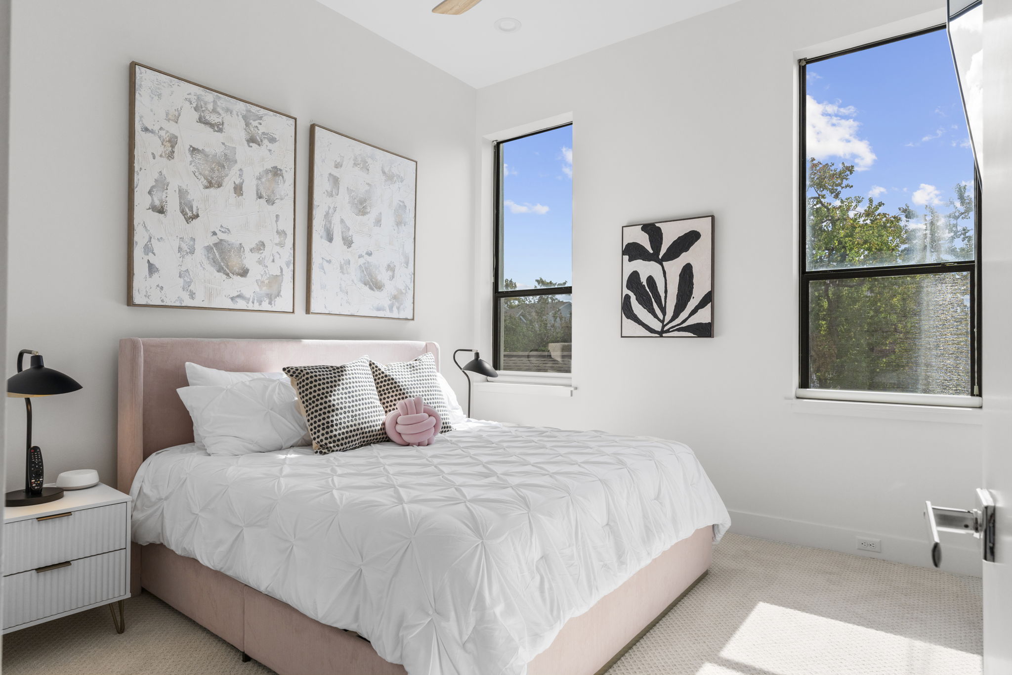 Bedroom with pink bed and white quilt