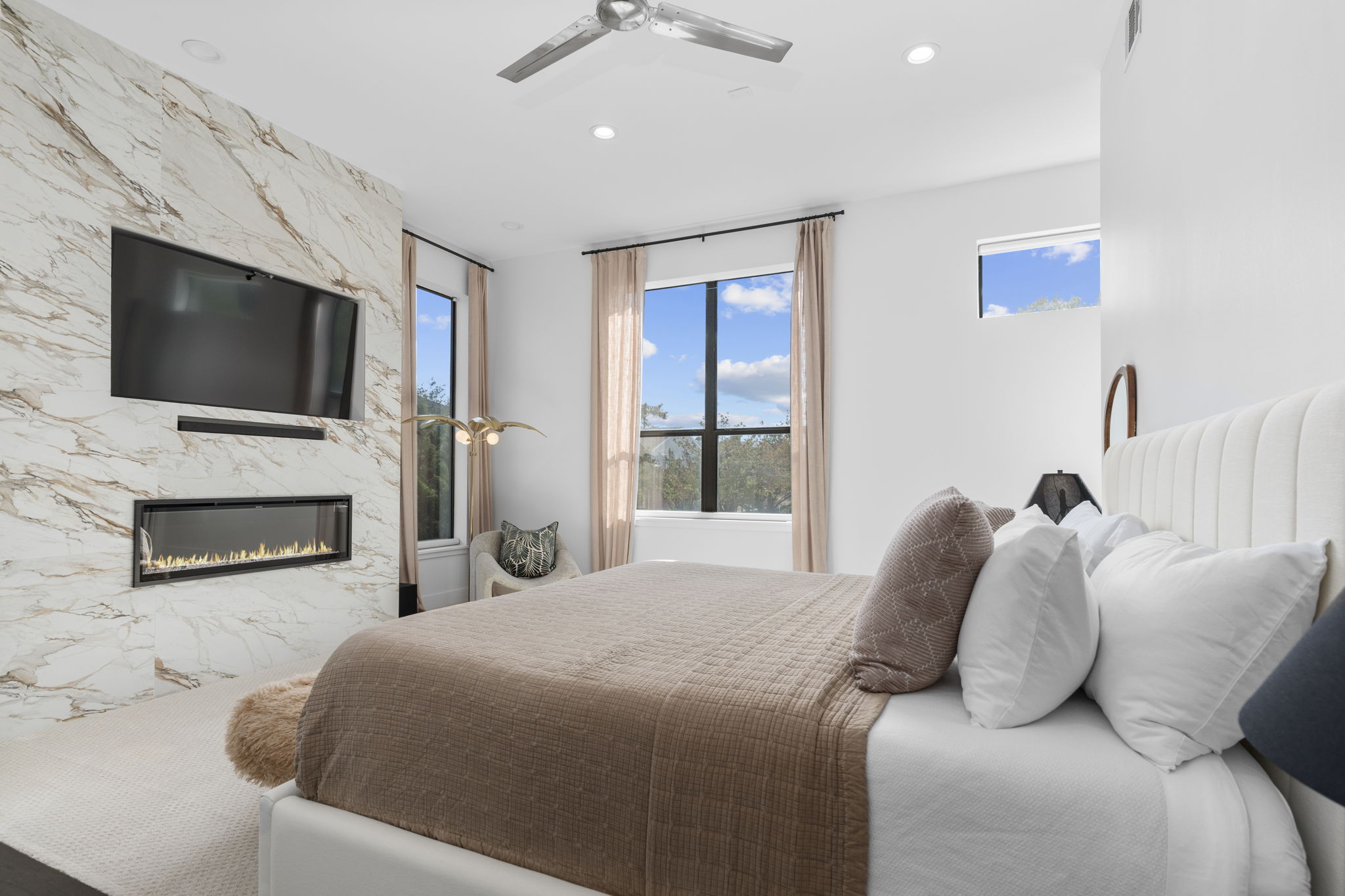 Primary bedroom with marble fireplace