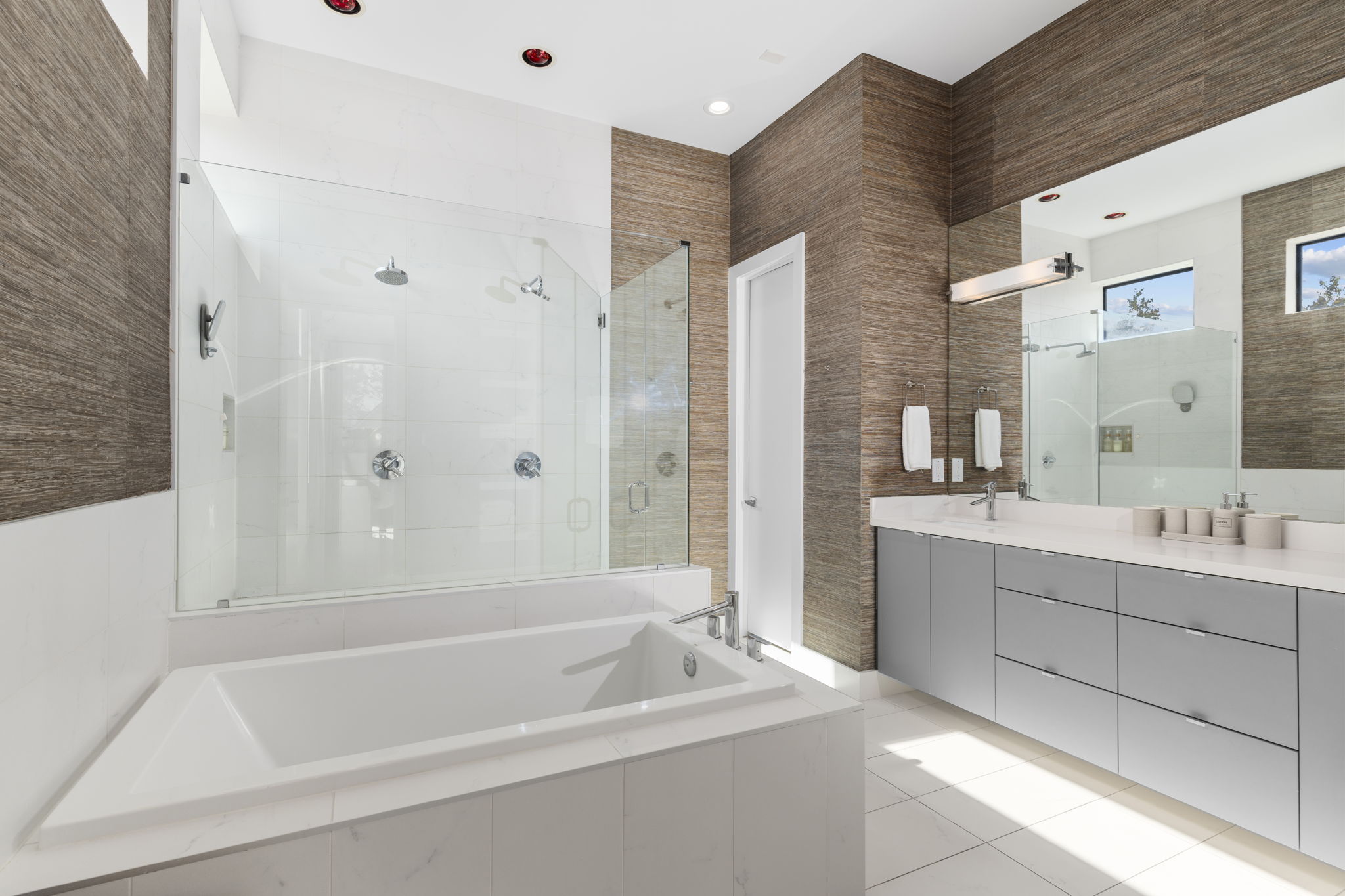 Master bathroom with standalone tub and chandelier